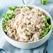 a bowl of turkey salad with lettuce on the sides