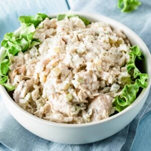 a bowl of turkey salad with lettuce on the sides