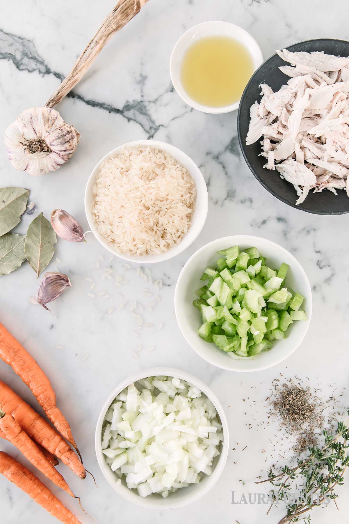 ingredients for chicken and rice soup laid out on a countertop