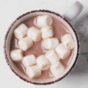 overhead view of a cup of homemade dairy free hot cocoa topped with mini marshmallows