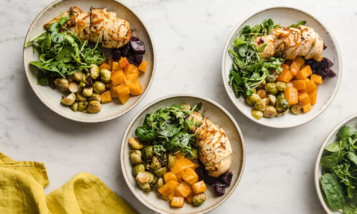 three dishes with chicken and roasted fall vegetables