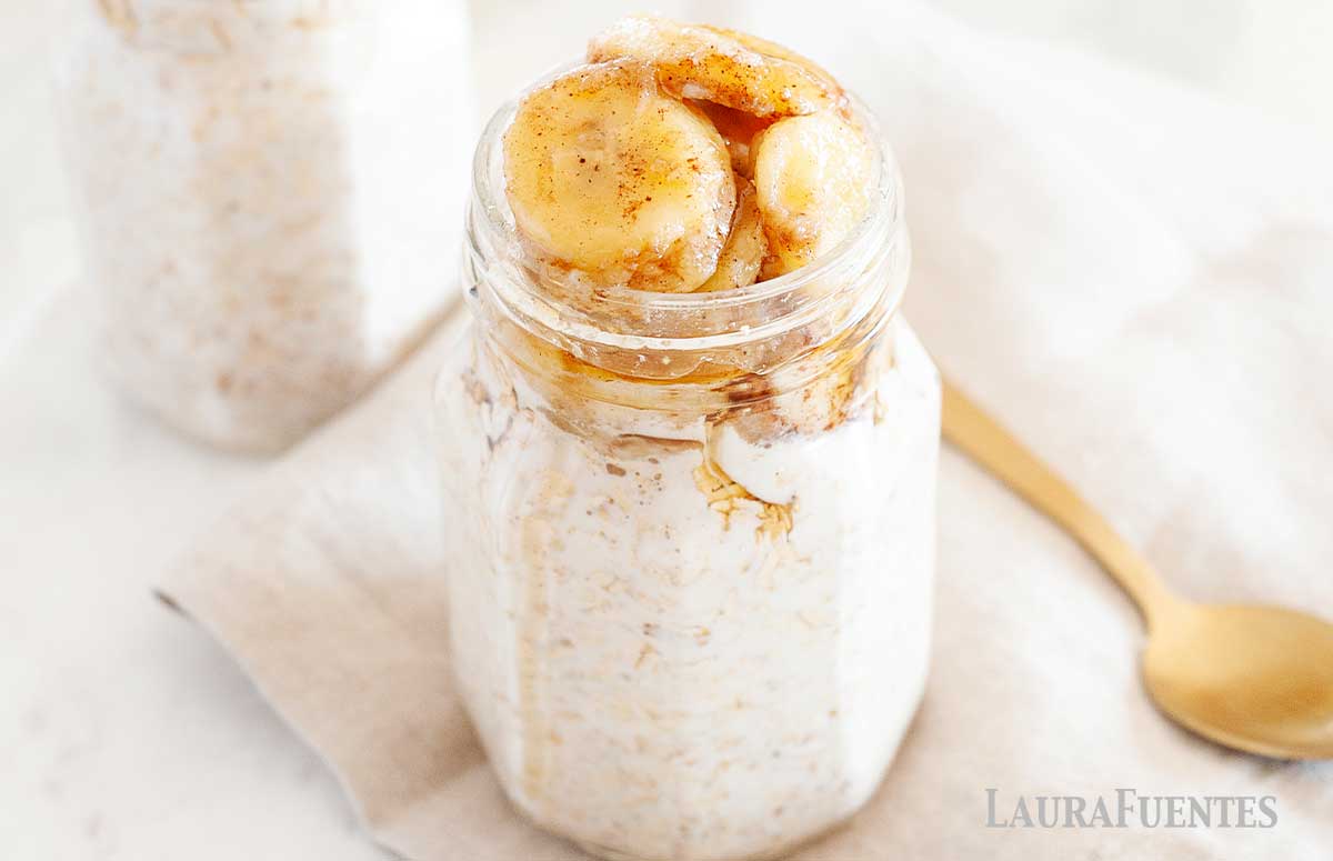 image: a jar of banana overnight oats on a table cloth