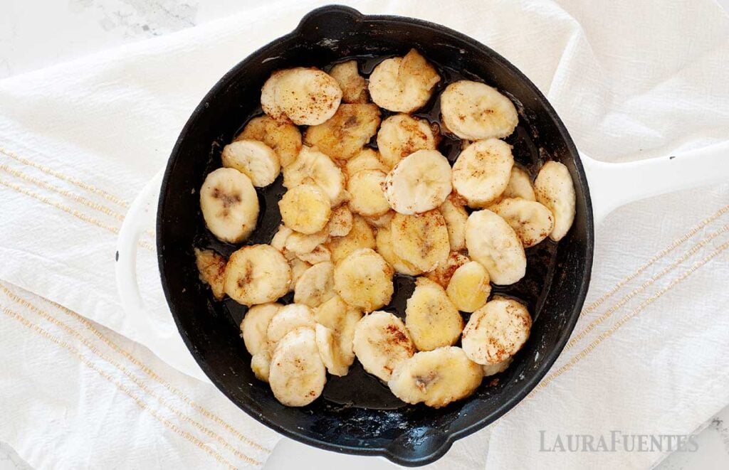image: sliced bananas in a skillet cooking