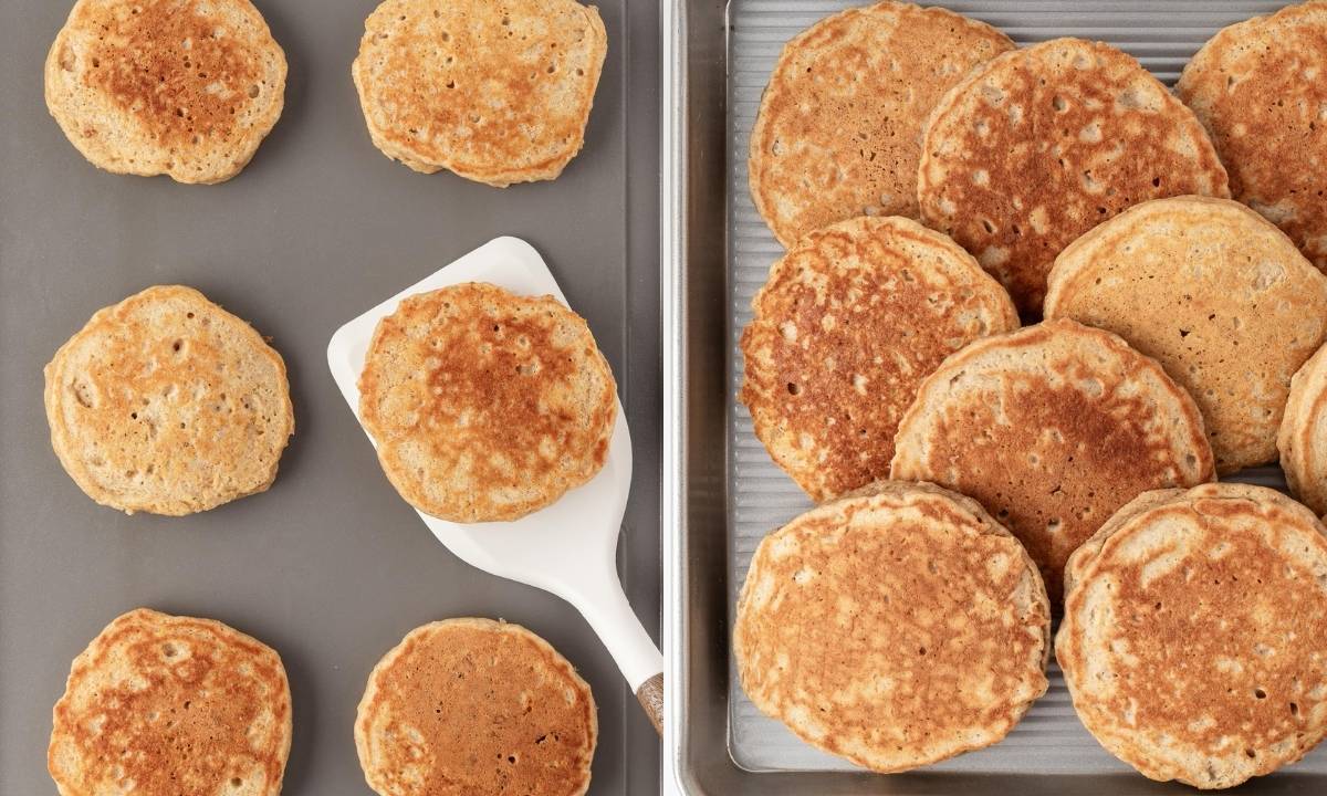 side by side image of cooking whole wheat pancakes on a griddle (left) and keeping them warm on a sheet pan (right)