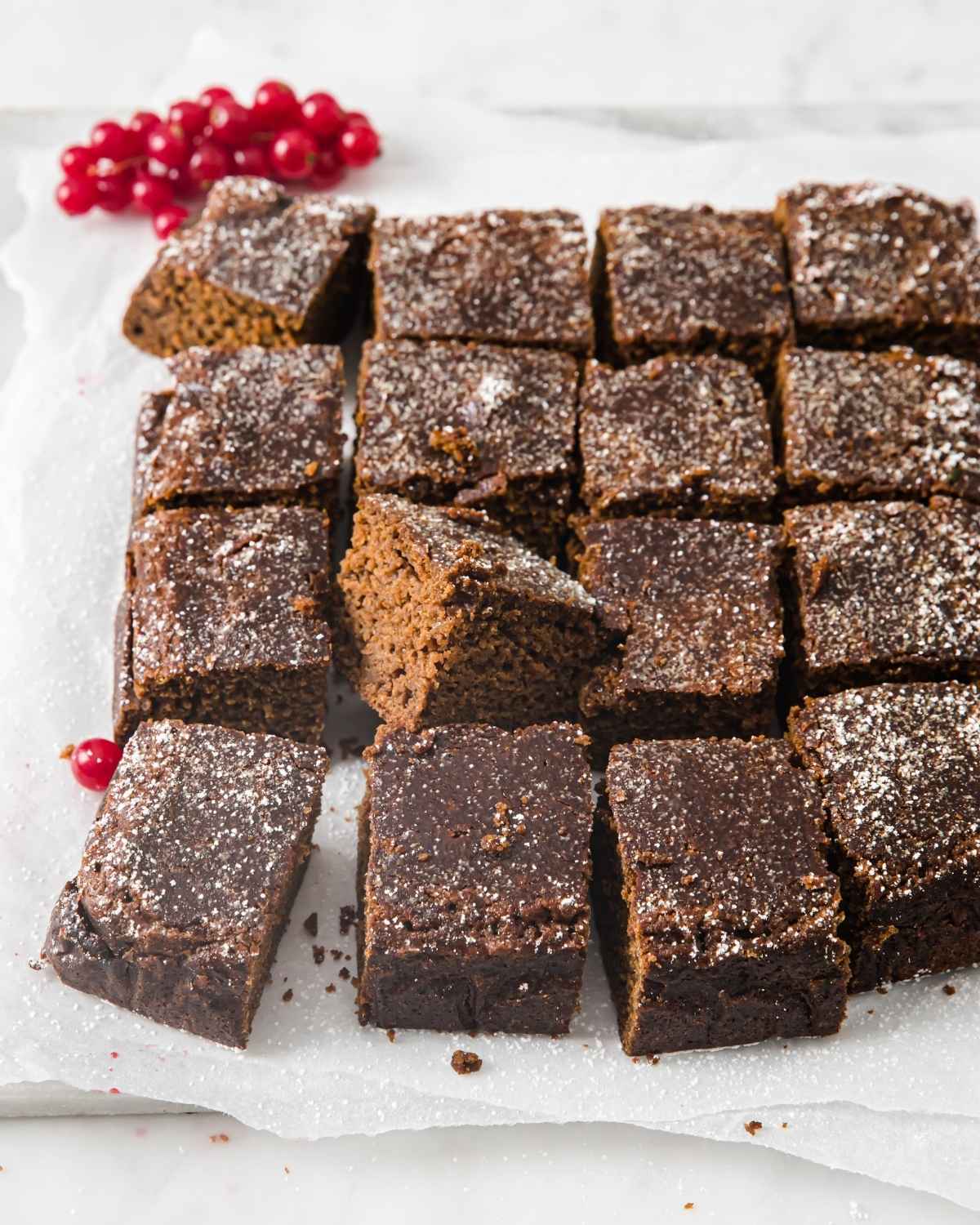 gingerbread cake sliced into 16 squares on a dish