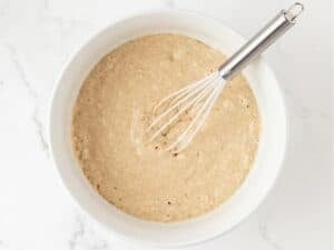 whole wheat pancake batter in a bowl with a whisk