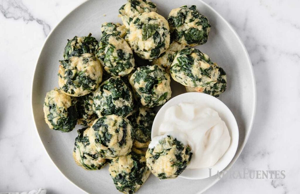 spinach balls on a plate with ranch dressing