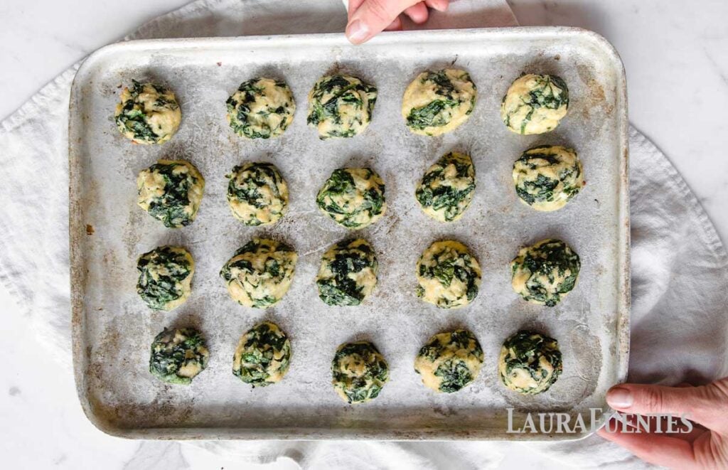 spinach balls on a baking sheet