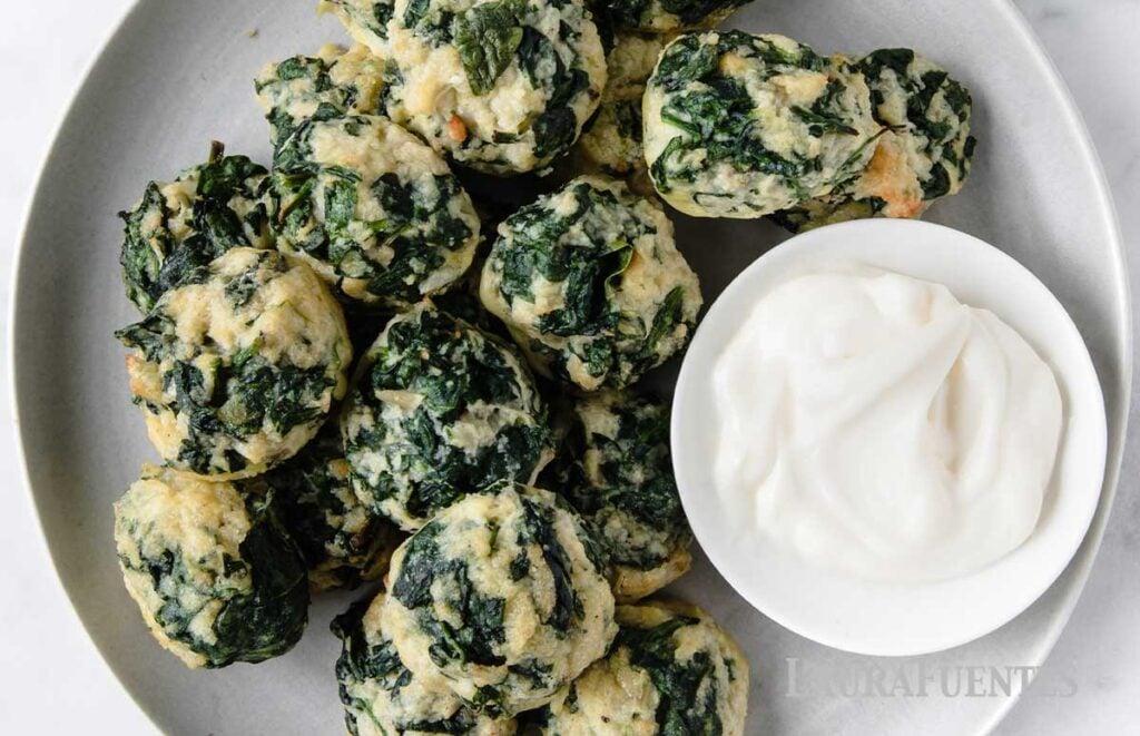 Large plate of spinach balls with dipping sauce