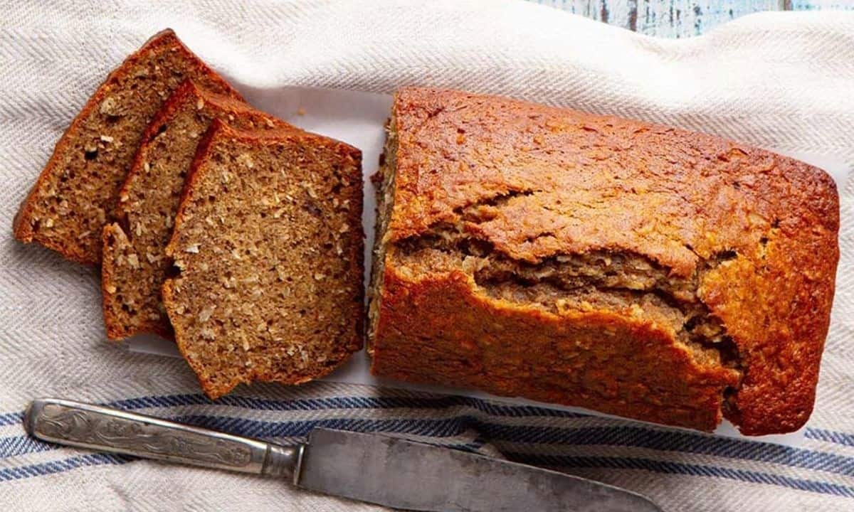 overhead view of a loaf of applesauce bread on a cutting board