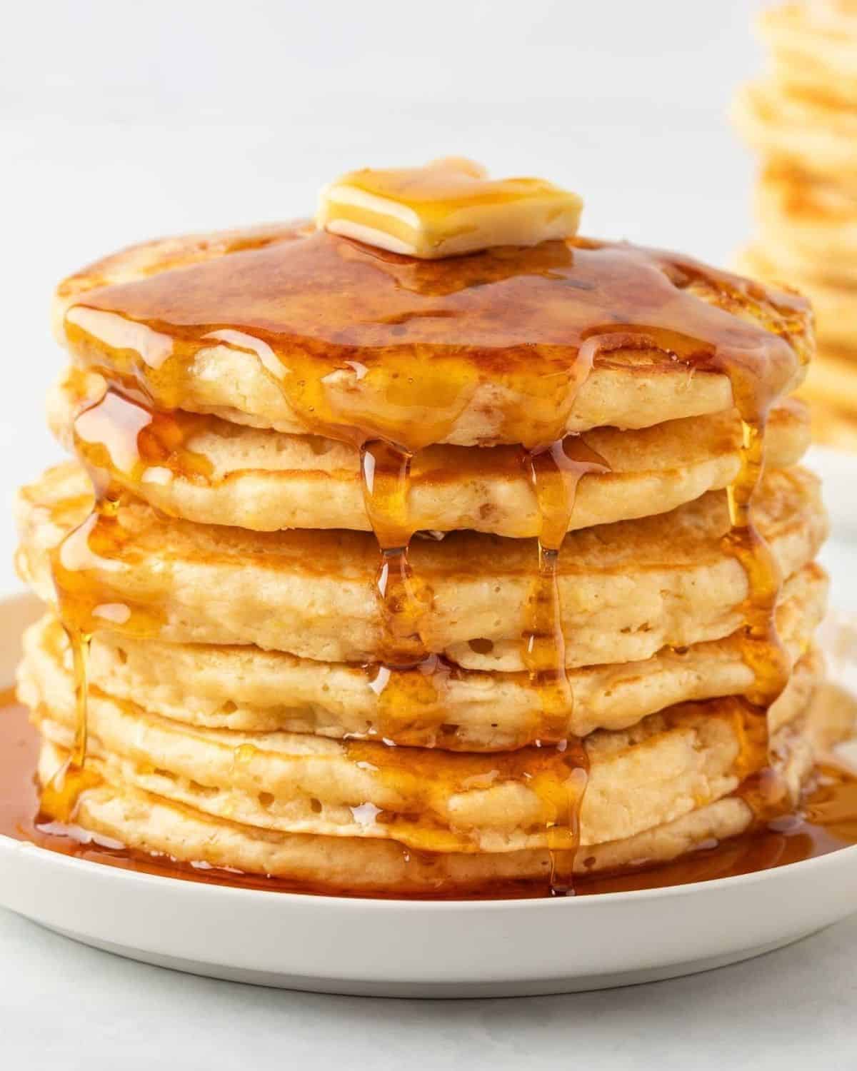 a stack of pancakes drizzled with syrup