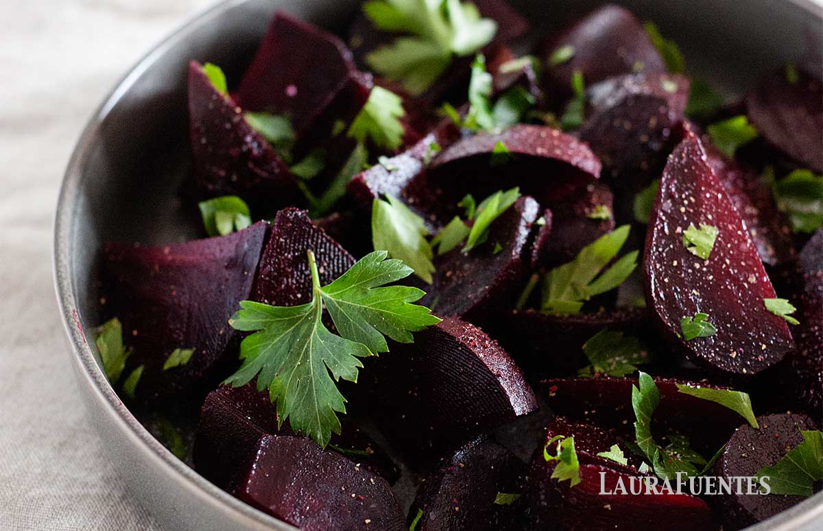 large dish of balsamic beets topped with greens