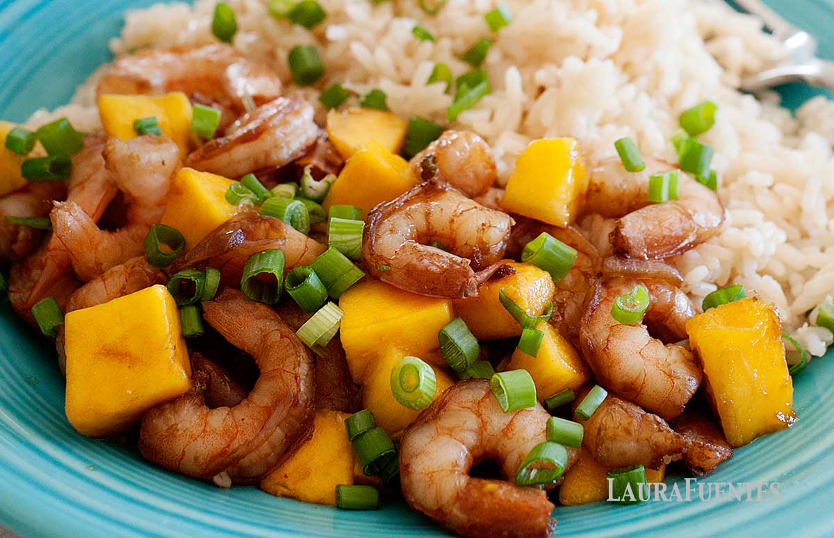 closeup of mango shrimp and rice on a blue plate