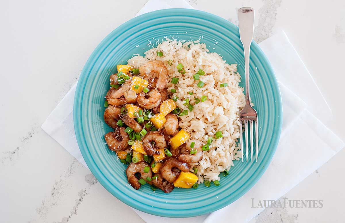 overhead view of blue plate with mango shrimp stir fry