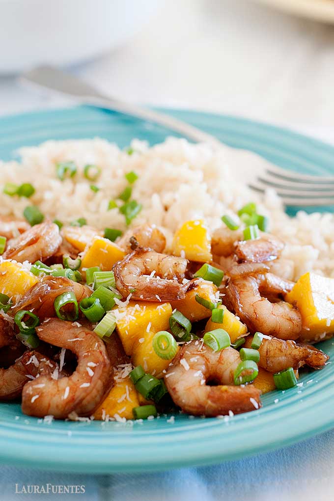 closeup of mango shrimp and rice on a blue plate