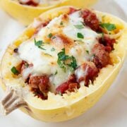 baked spaghetti squash half filled with meat sauce and cheese