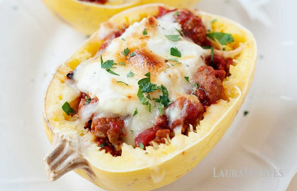 baked spaghetti squash half filled with meat sauce and cheese