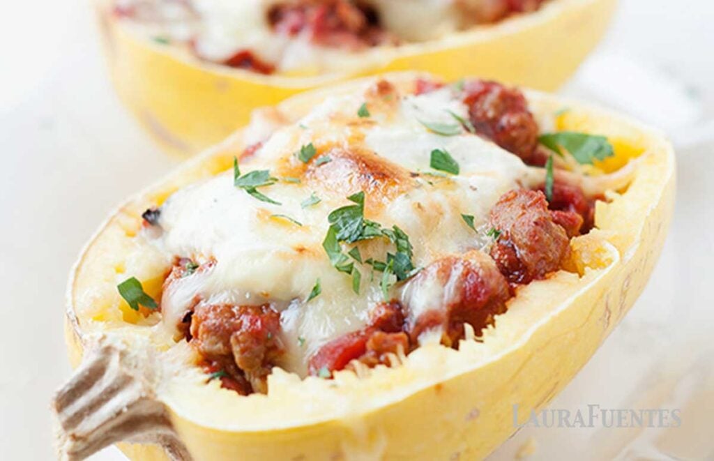 baked spaghetti squash half filled with meat sauce and cheese
