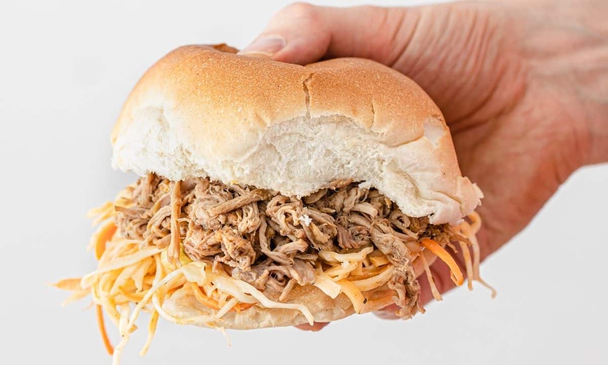 a hand holding cochon de lait