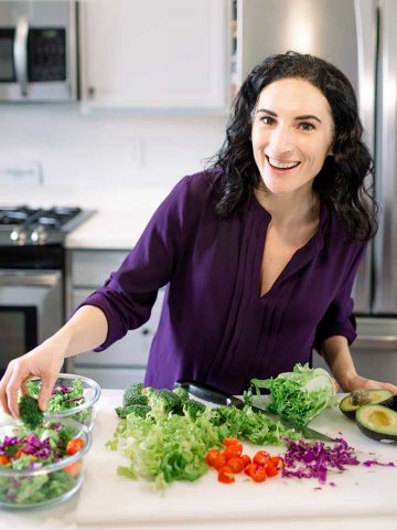 woman chopping vegetables at a countertop