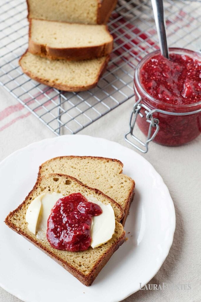 loaf of grain free bread, sliced. two slices on a plate topped with chia seed jam