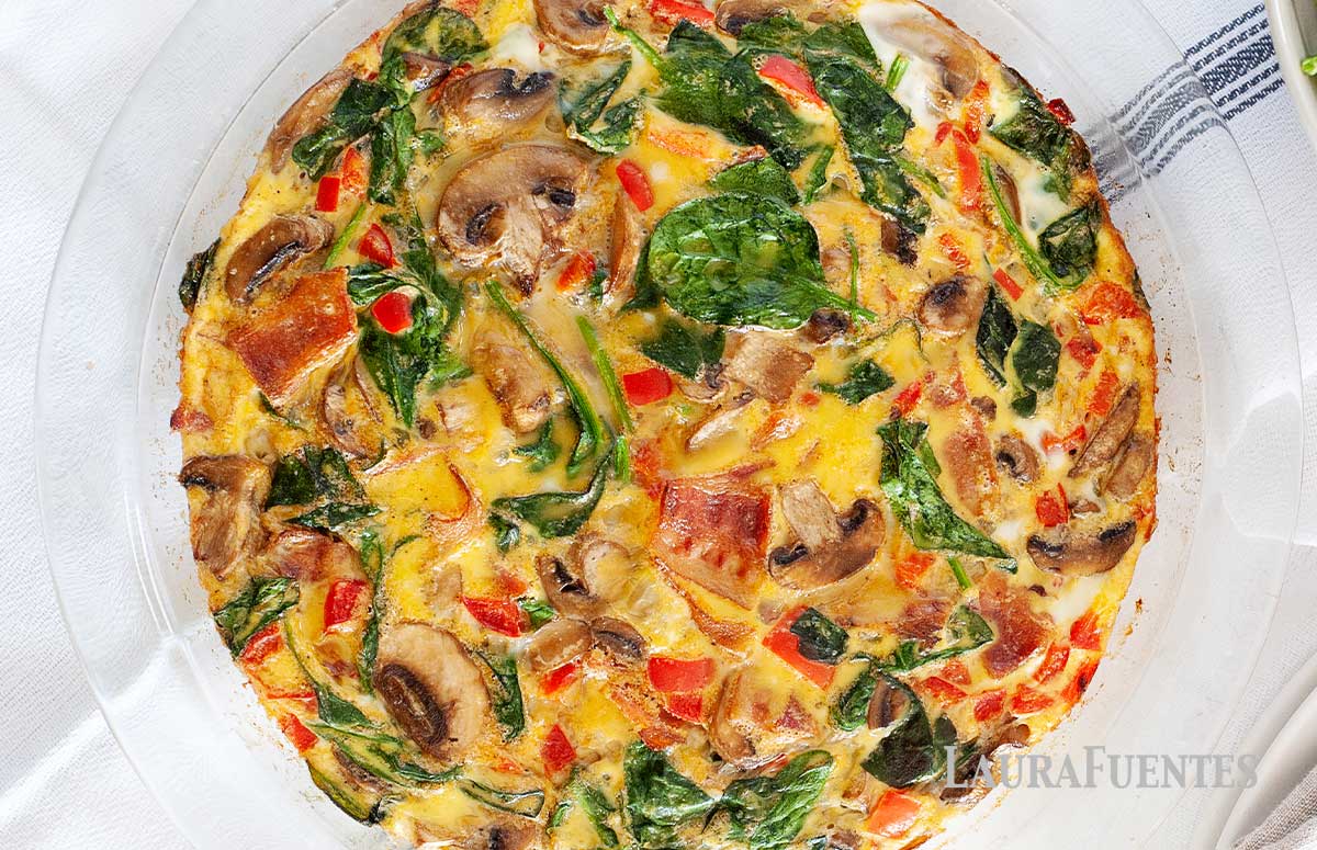 spinach bacon frittata in a pan 