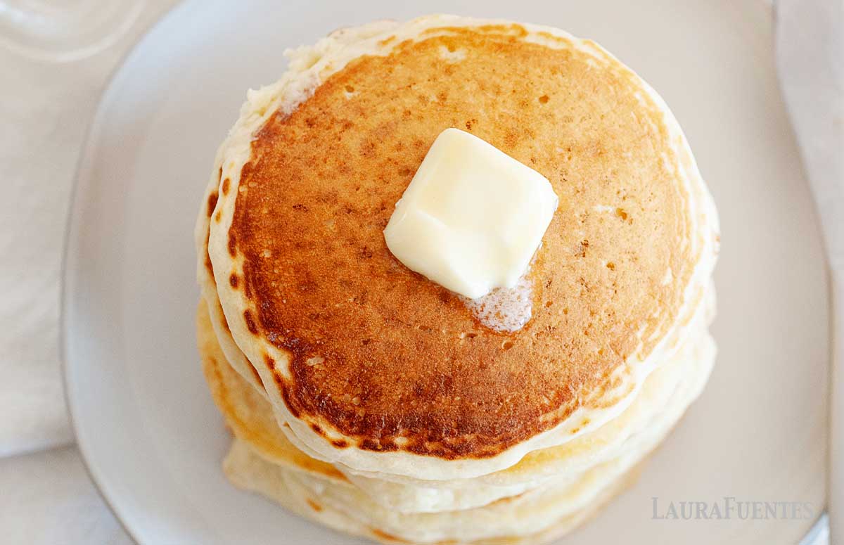 Image: overhead view of stack of pancakes with butter