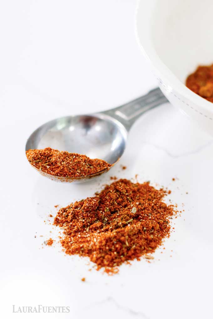 homemade seasoning spilled on a countertop with a large tablespoon