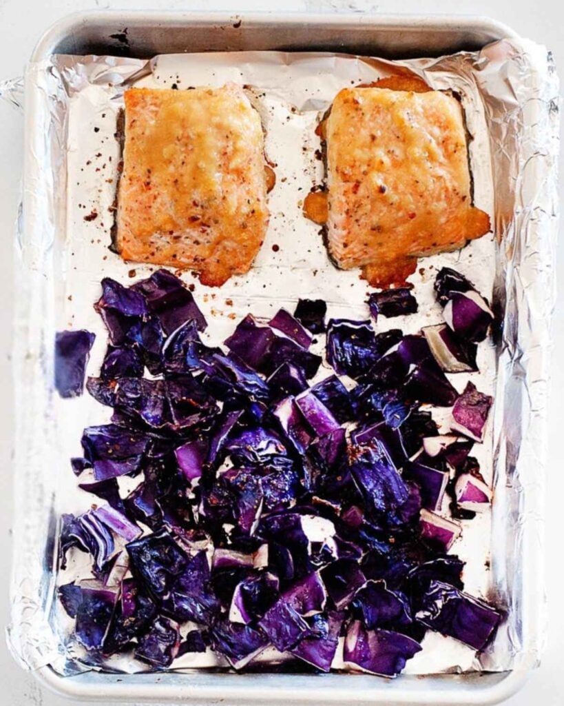 baking dish with two pieces of salmon and chopped cabbage