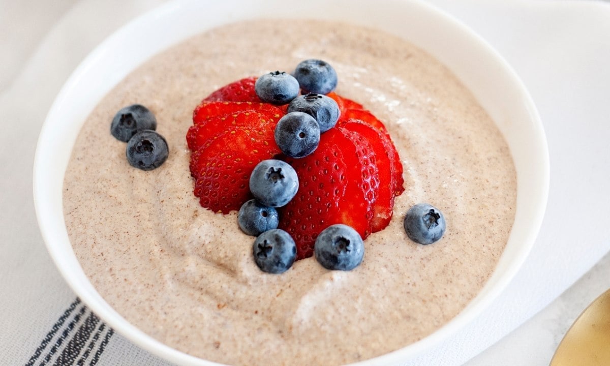 bowl of paleo oatmeal with berries on top