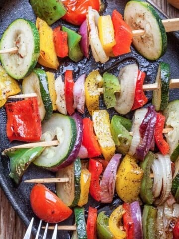 overhead view of veggie kabobs in a black tray