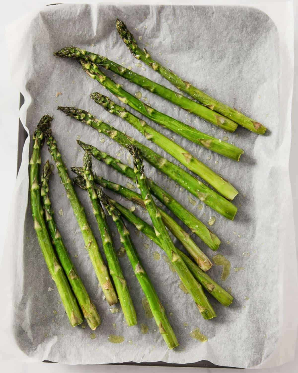 roasted asparagus in a lined sheet pan