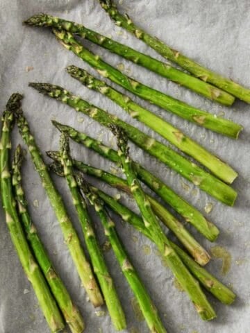 roasted asparagus in a lined sheet pan