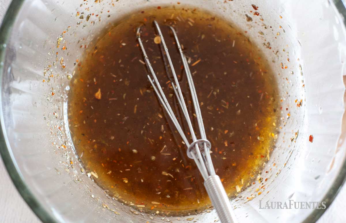 bowl of fajita marinade with a whisk