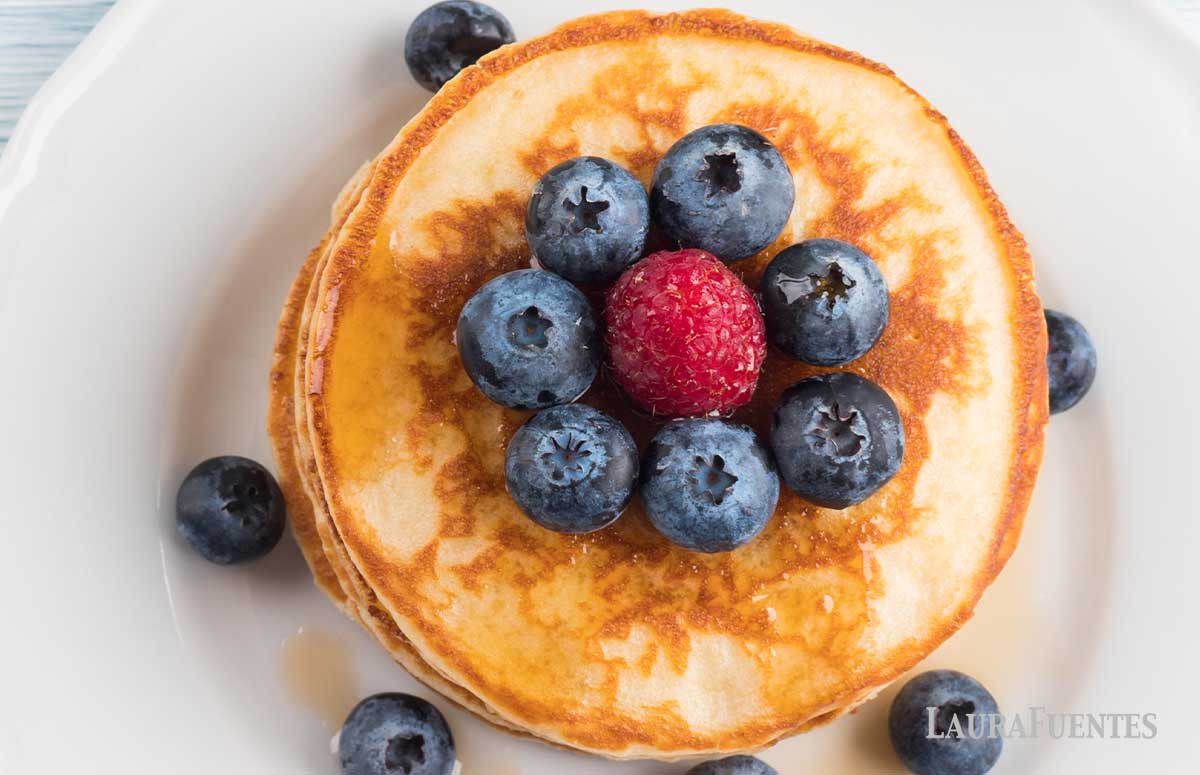 overhead look at stack of pancakes topped with berries