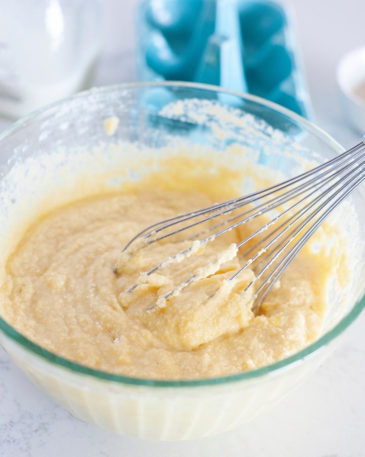 low carb coconut flour pancake batter in a bowl with wire whisk