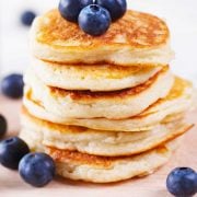 coconut flour pancakes in a stack with blueberries