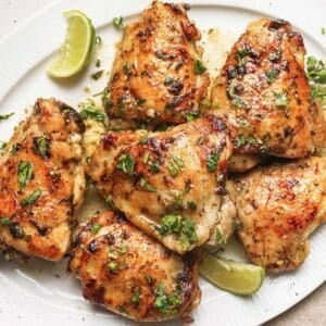 overhead view of cooked chicken thighs marinated in a cilantro-lime marinade