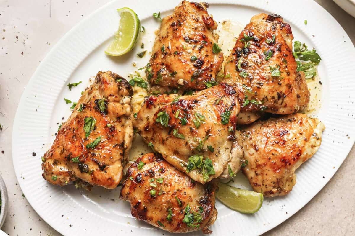 overhead view of cooked chicken thighs marinated in a cilantro-lime marinade