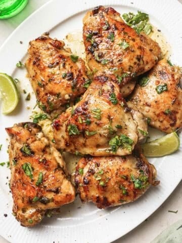 overhead view of cooked chicken thighs marinated in a cilantro-lime marinade