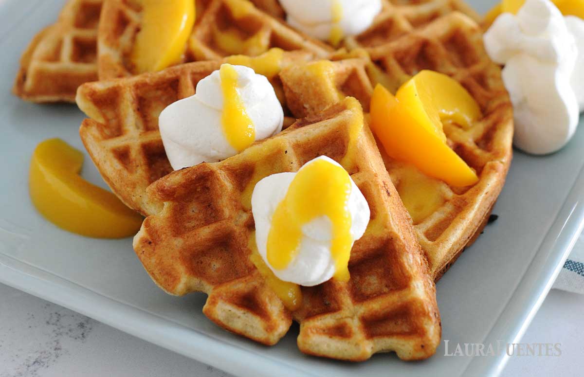 waffles topped with peac slices and peach syrup