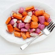 large platter filled with roasted carrots and radishes