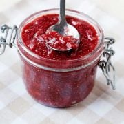 homemade chia seed jam in a glass jar with a spoon