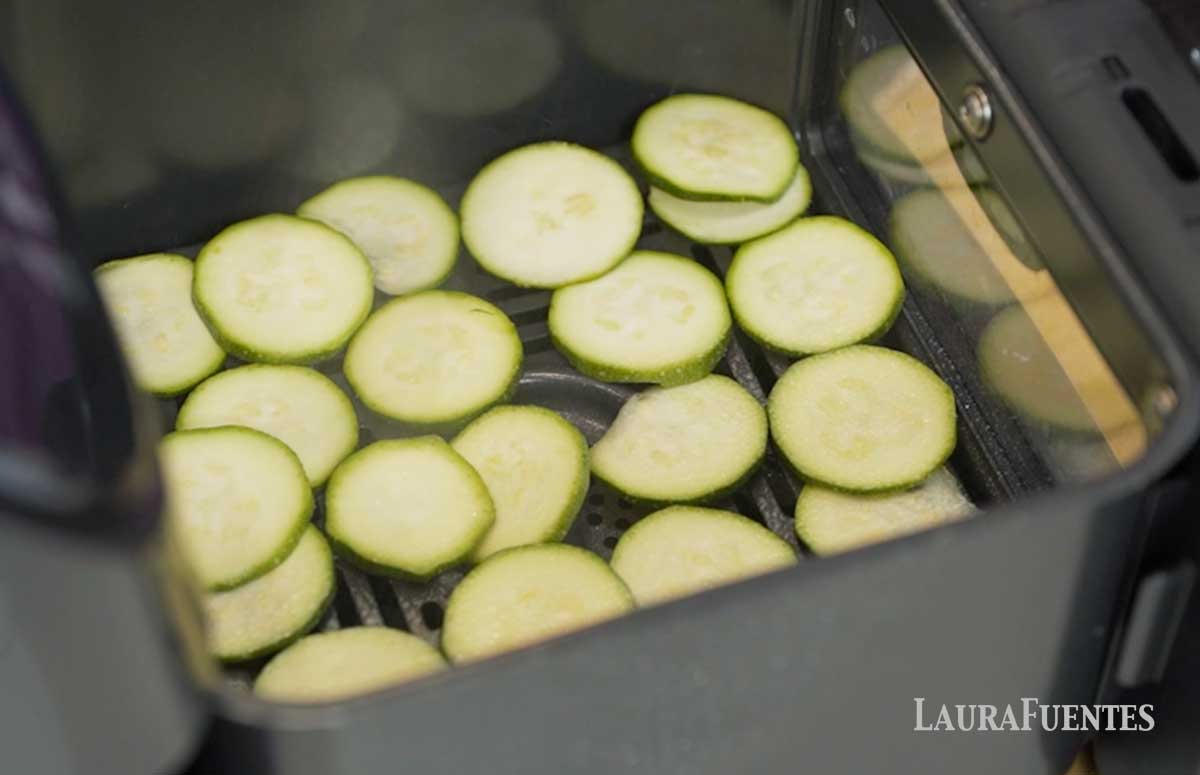zucchini slices in an air fryer tray