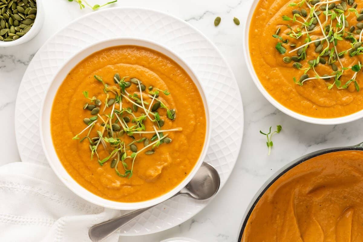 overhead view of two bowls with acorn squash soup