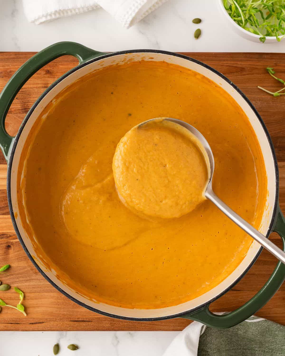 using a ladle to serve acorn squash soup