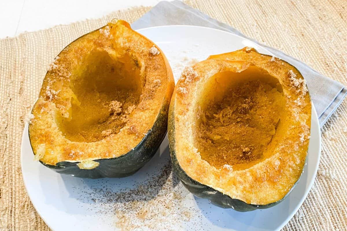 two cooked acorn squash halves on a plate