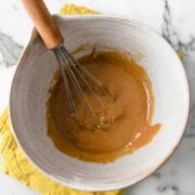 bowl of peanut butter sauce with a whisk