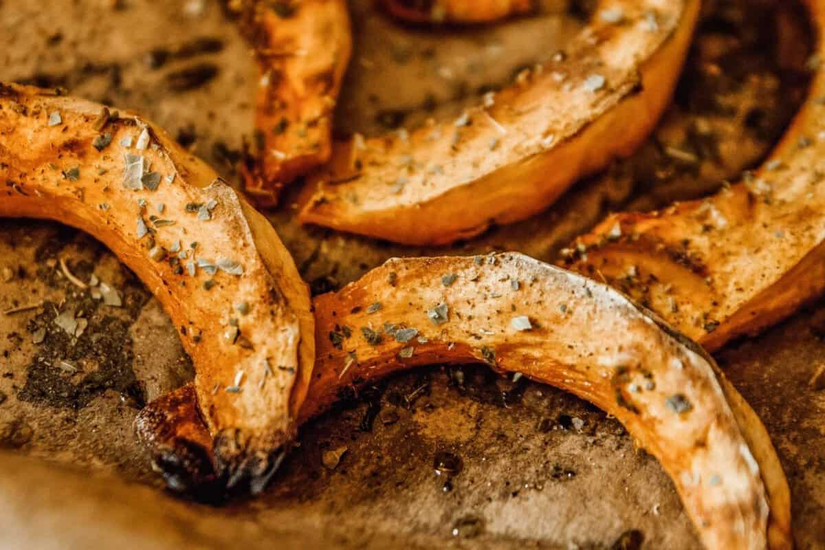 roasted acorn squash slices on a baking sheet