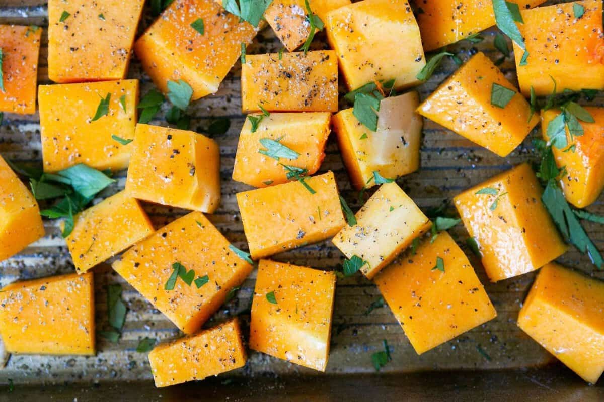 roasted butternut squash cubes on a baking sheet